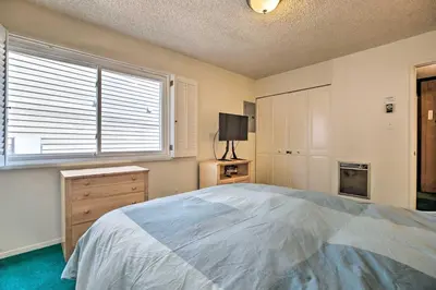 a bedroom with a large bed and a window at Mammoth Lakes Townhome Less Than 2 Mi to Ski Area! in Mammoth Lakes