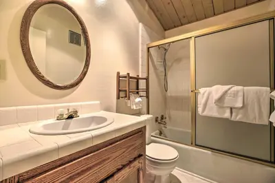 a bathroom with a sink and a mirror and a toilet at Mammoth Lakes Townhome Less Than 2 Mi to Ski Area! in Mammoth Lakes