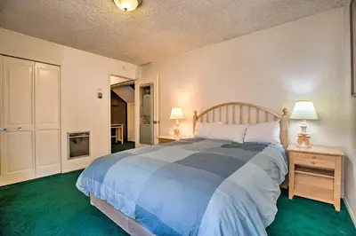 a bedroom with a large bed with a blue comforter at Mammoth Lakes Townhome Less Than 2 Mi to Ski Area! in Mammoth Lakes