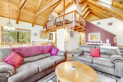 a living room with a couch and a table at Tranquility in the Woods in Arnold