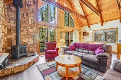 a living room with a couch and a fireplace at Tranquility in the Woods in Arnold