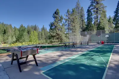 a tennis court with a ping pong table on it at Paws Place in Arnold