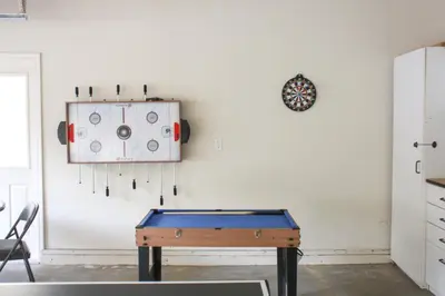 a ping pong table in a room with a wall at The 19th Hole in Groveland