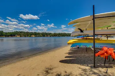 a group of umbrellas on a beach with the water at The 19th Hole in Groveland