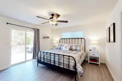 a bedroom with a bed and a ceiling fan at The 19th Hole in Groveland
