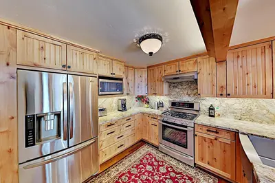 a kitchen with wooden cabinets and a stainless steel refrigerator at Bitterbrush 25 in Incline Village