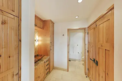 a kitchen with wooden cabinets and a door at Bitterbrush 25 in Incline Village