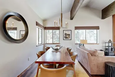 a dining room with a table and a couch at Lakeshore Townhome 20 in Incline Village