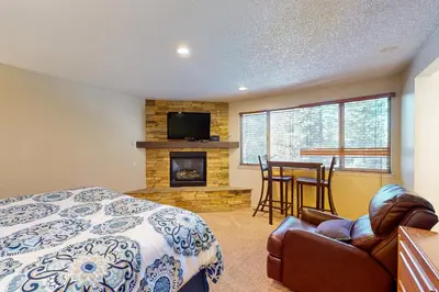 a bedroom with a bed and a fireplace at Lake Village Townhouse B in Zephyr Cove