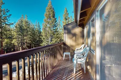 two white chairs sitting on the balcony of a house at Lake Village Townhouse B in Zephyr Cove