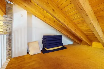 a attic room with a stack of blue blankets at Lake Village Townhouse B in Zephyr Cove