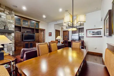 a dining room with a large wooden table and chairs at Northstar Lodge Luxury in Kingswood Estates