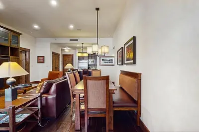 a dining room and living room with a table and chairs at Northstar Lodge Luxury in Kingswood Estates
