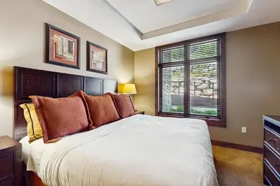 a bedroom with a large bed and a window at Northstar Lodge Luxury in Kingswood Estates