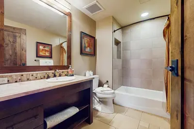 a bathroom with a sink and a toilet and a tub at Northstar Lodge Luxury in Kingswood Estates