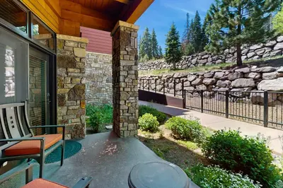 a porch of a house with a stone wall at Northstar Lodge Luxury in Kingswood Estates
