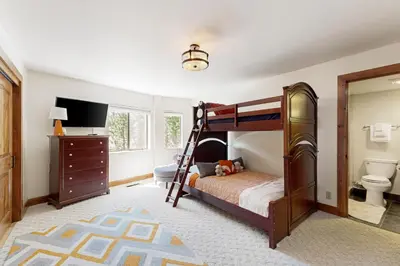 a bedroom with a bunk bed and a bathroom at Tyner Dreams in Incline Village