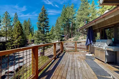 a wooden deck with a grill on a house at Tyner Dreams in Incline Village