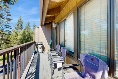 a row of chairs sitting on the balcony of a house at Katherine Court Townhouse in Stateline