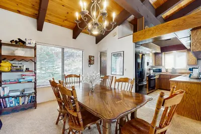 a kitchen and dining room with a wooden table and chairs at Katherine Court Townhouse in Stateline