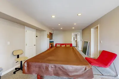 a large room with a large table and a red chair at Lake View Escape in Incline Village