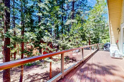 a wooden deck with trees on a house at Boothill Adventures in Incline Village