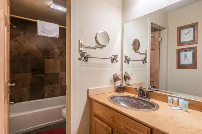 a bathroom with a sink and a tub and a mirror at New Listing 2 bedroom and Loft 2 bath Summit E Bldg 12 condo sleeps 8 Steps to Eagle Lodge Chair 15 in Mammoth Lakes