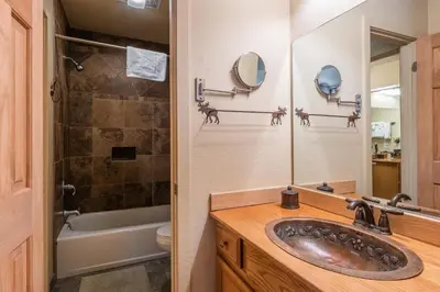 a bathroom with a sink and a tub and a mirror at New Listing 2 bedroom and Loft 2 bath Summit E Bldg 12 condo sleeps 8 Steps to Eagle Lodge Chair 15 in Mammoth Lakes