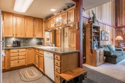 a kitchen with wooden cabinets and a sink at New Listing 2 bedroom and Loft 2 bath Summit E Bldg 12 condo sleeps 8 Steps to Eagle Lodge Chair 15 in Mammoth Lakes