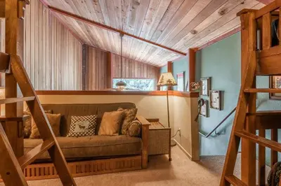 a living room with a couch and a wooden ceiling at New Listing 2 bedroom and Loft 2 bath Summit E Bldg 12 condo sleeps 8 Steps to Eagle Lodge Chair 15 in Mammoth Lakes