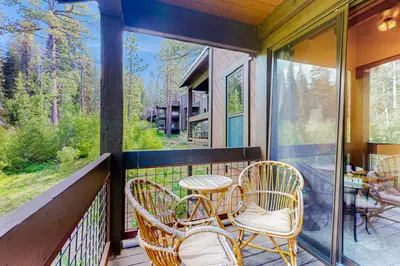 a screened in porch with chairs and a table at Aspen Grove Condo in Truckee