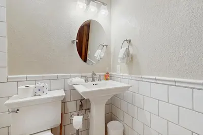 a bathroom with a sink and a toilet and a mirror at Conifer Donner in Truckee