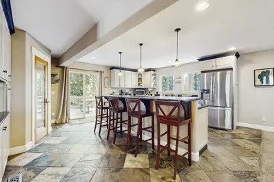 a kitchen with a large island with bar stools at Skyline Manor in South Lake Tahoe