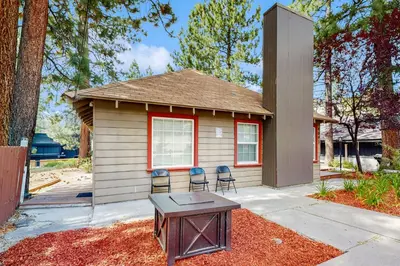 a small house with chairs and a table in front of it at Manzanita Holiday 4 in South Lake Tahoe