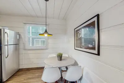 a dining room with a table and white chairs at Manzanita Holiday 4 in South Lake Tahoe