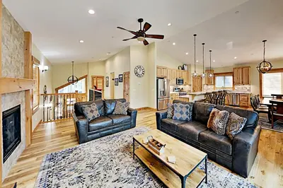 a living room with two leather couches and a fireplace at Saponi Escape in South Lake Tahoe