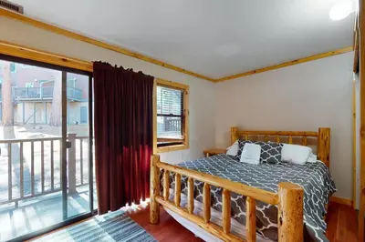 a bedroom with a bed and a balcony at Ski Run Village 11 in South Lake Tahoe