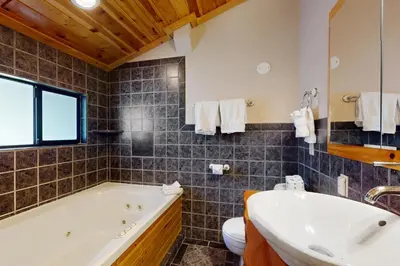 a bathroom with a tub and a toilet and a sink at Ski Run Village 11 in South Lake Tahoe