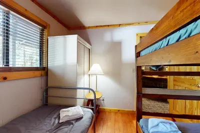 a bedroom with two bunk beds and a window at Ski Run Village 11 in South Lake Tahoe