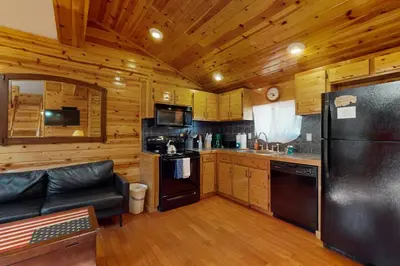 a kitchen with a black refrigerator in a cabin at Ski Run Village 11 in South Lake Tahoe