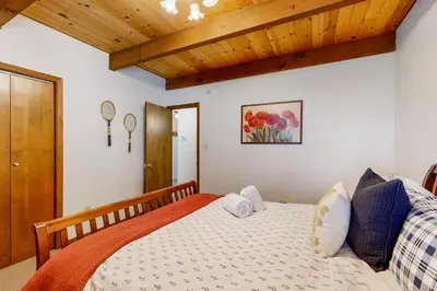 a bedroom with a bed and a wooden ceiling at Wolfgang Dreams in Truckee