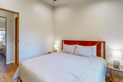 a bedroom with a white bed with a red headboard at Koyukon Escape in South Lake Tahoe