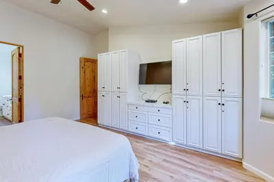a white bedroom with a bed and a tv at Koyukon Escape in South Lake Tahoe