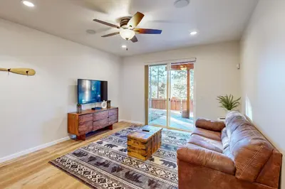 a living room with a couch and a flat screen tv at Koyukon Escape in South Lake Tahoe