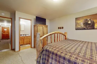 a bedroom with a bed and a picture of a bear on the wall at Cozy Tahoe Donner Retreat in Truckee