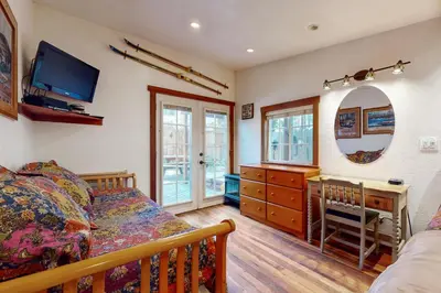 a bedroom with a bed and a dresser and a mirror at Pioneer Palace in South Lake Tahoe