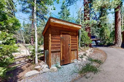 a wooden out house in the middle of a forest at Pioneer Palace in South Lake Tahoe
