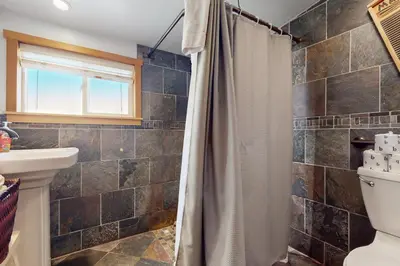a bathroom with a shower and a toilet at Pioneer Palace in South Lake Tahoe