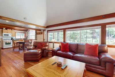 a living room with a leather couch and a table at Pioneer Palace in South Lake Tahoe