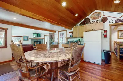 a kitchen and dining room with a table and a refrigerator at Pioneer Palace in South Lake Tahoe
